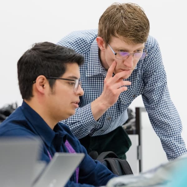 Student being mentored by a lecturer in an MRes class