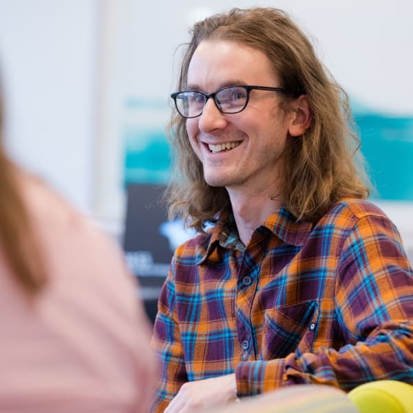 Student smiling at another student