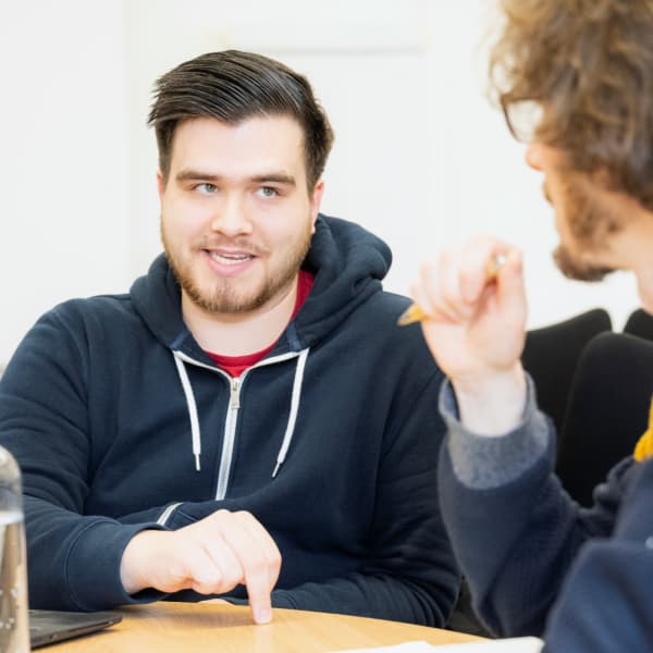 Student discussing research with another student