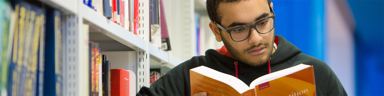 Person in the library reading a book