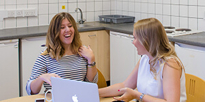 Two students at a kitchen table