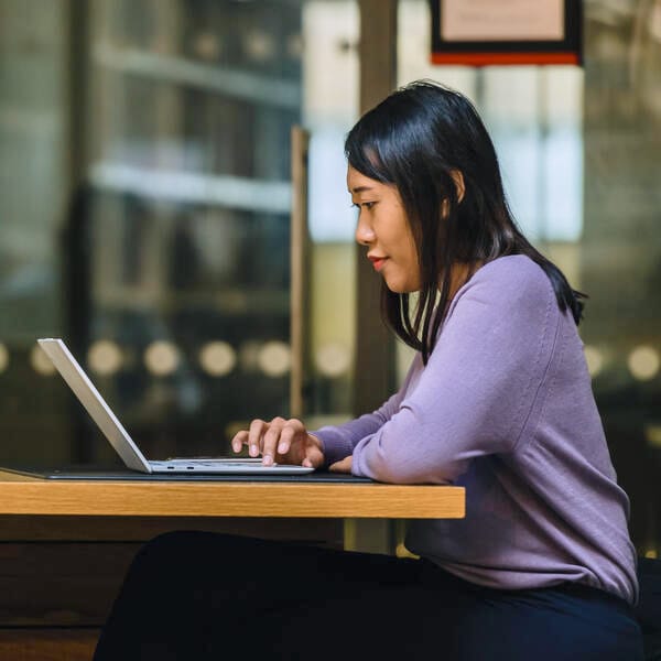 A student using a laptop in the library.