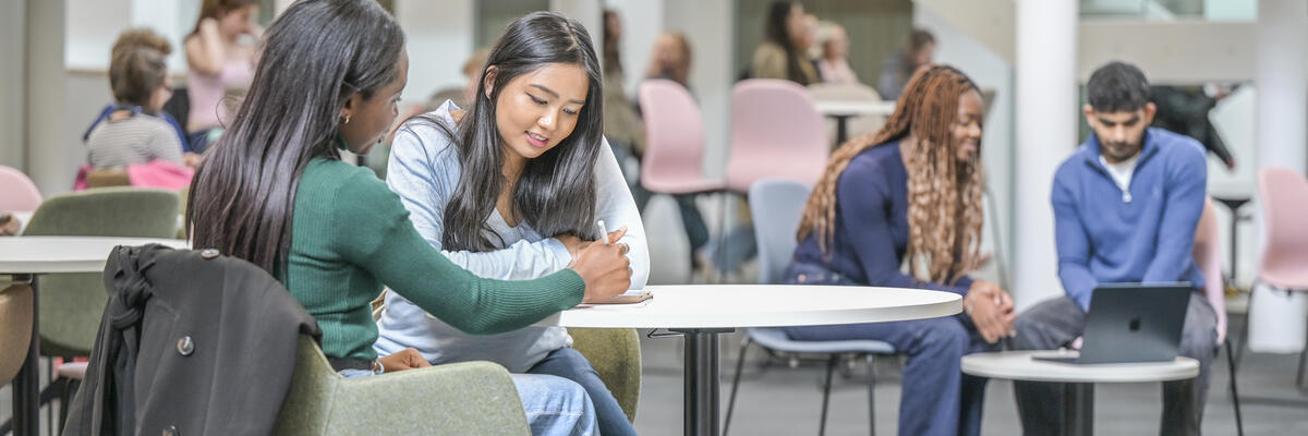 Students in discussion with in a lecture theatre