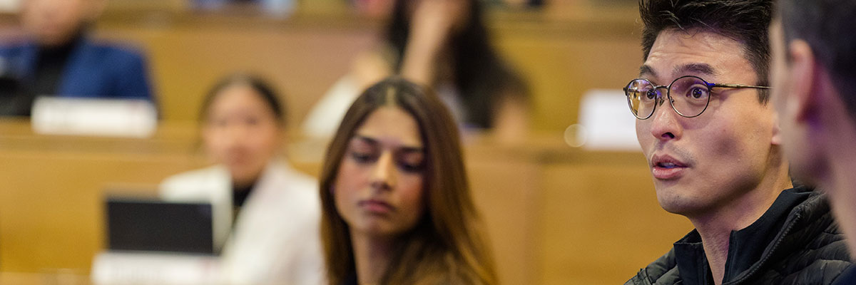 Students in discussion with in a lecture theatre