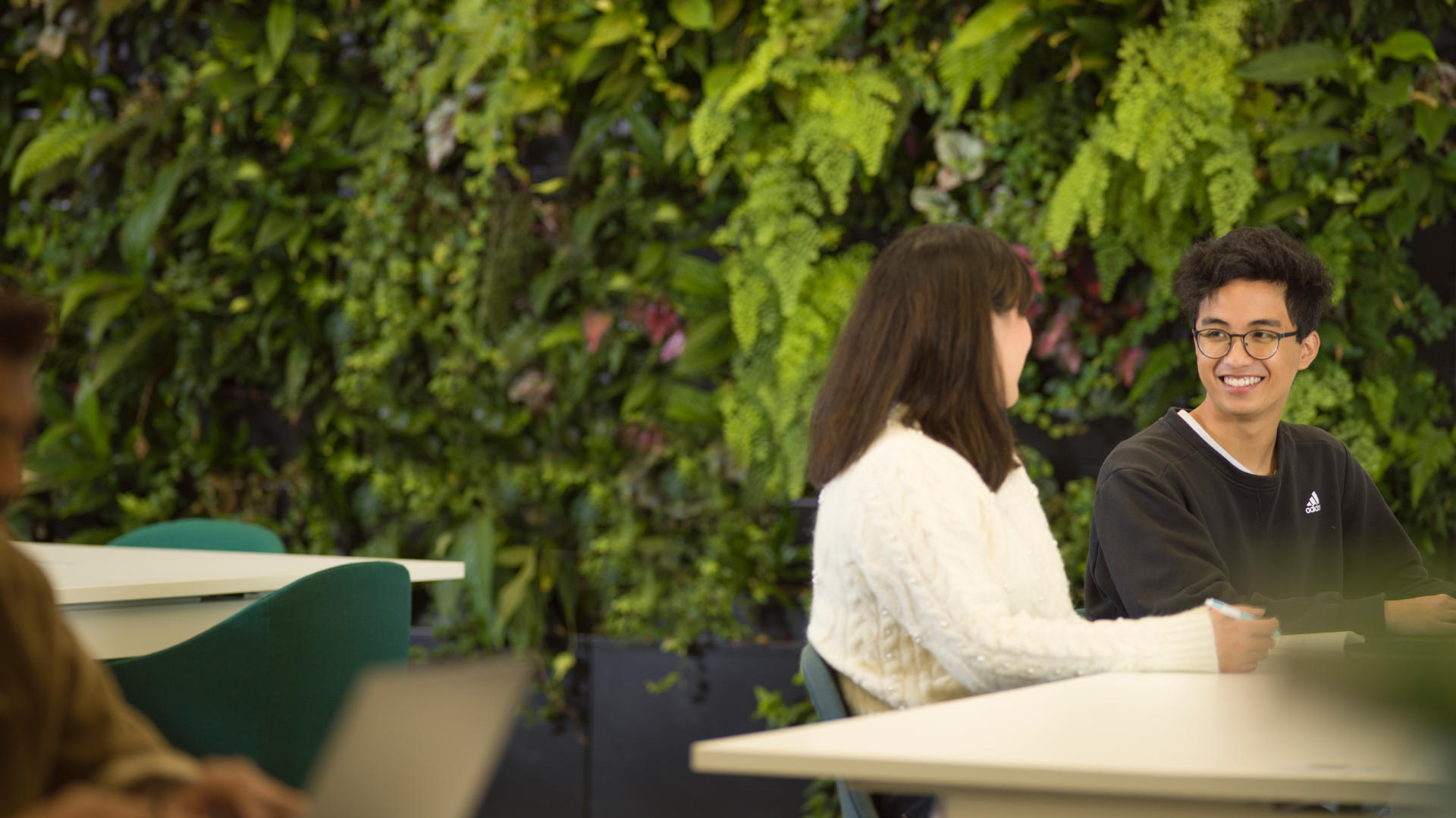 Students at a table in the LEC Atrium