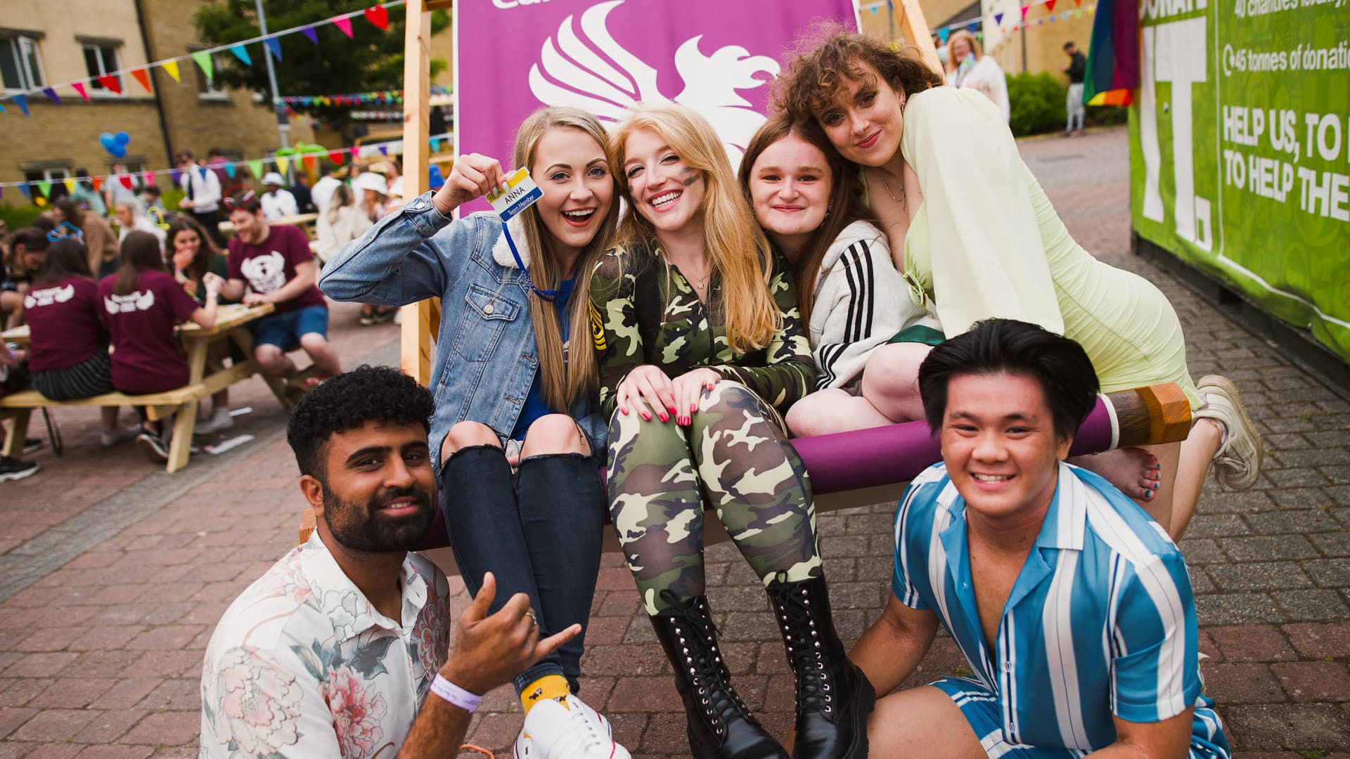 Students in a large deckchair at a college party