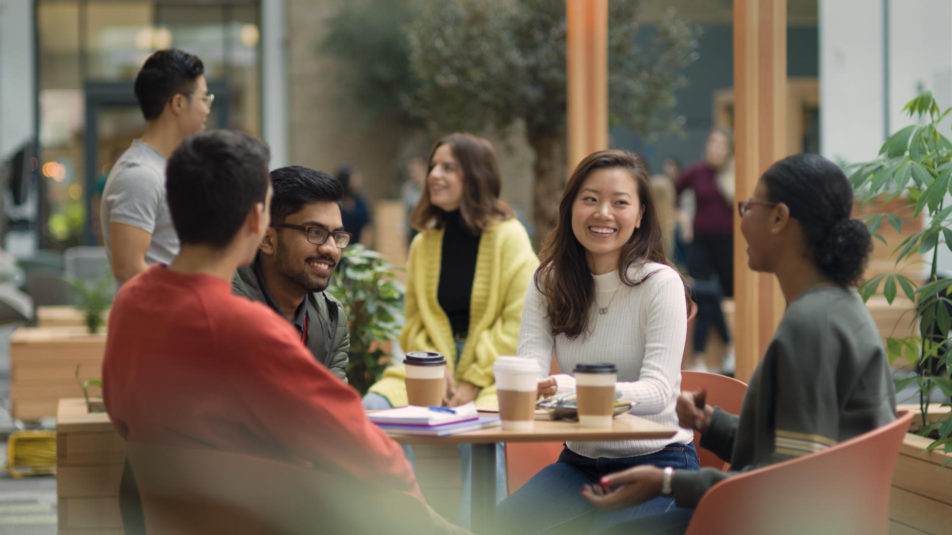 Students at a table in the LEC Atrium