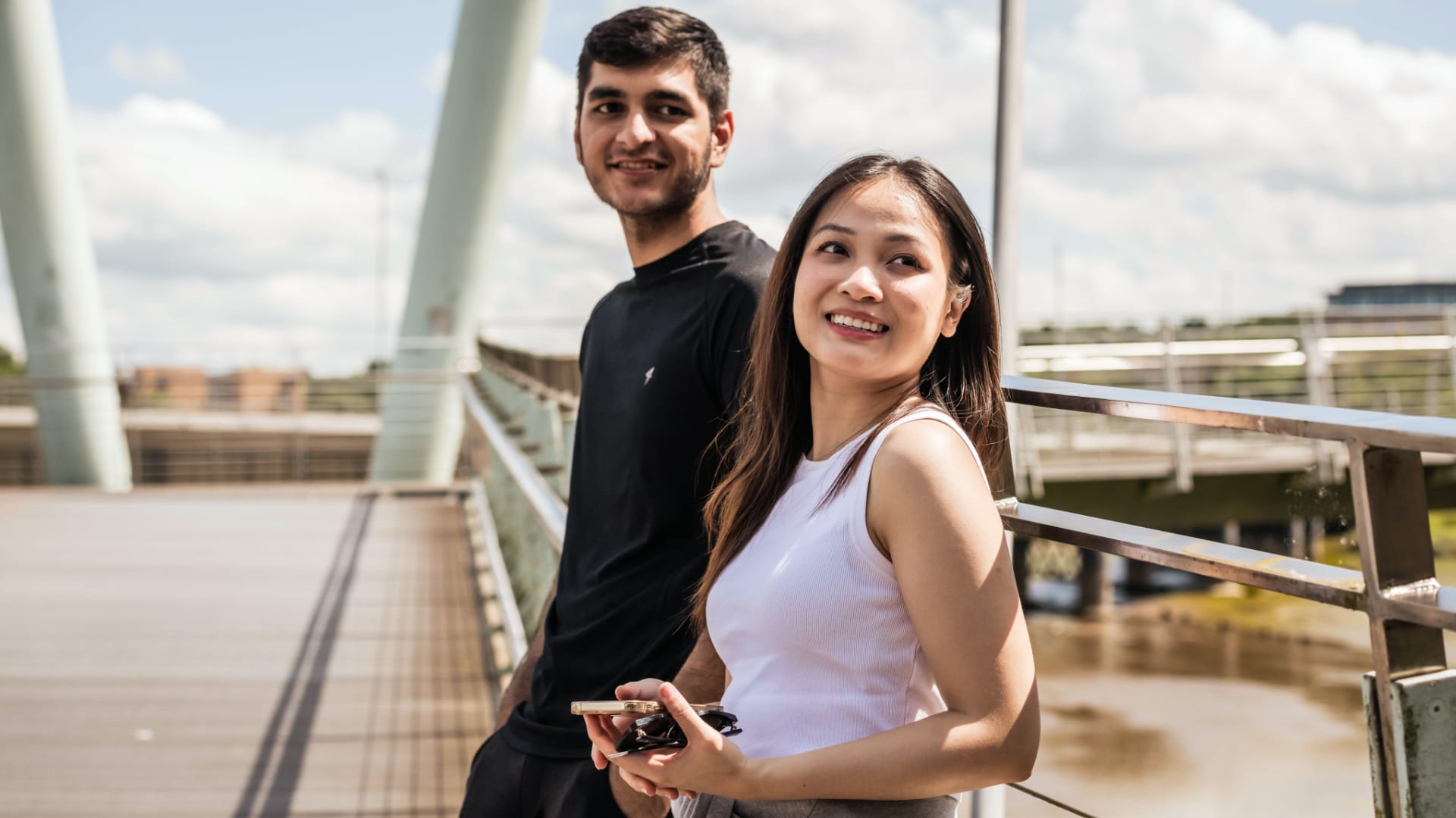Two students on a footbridge over the River Lune