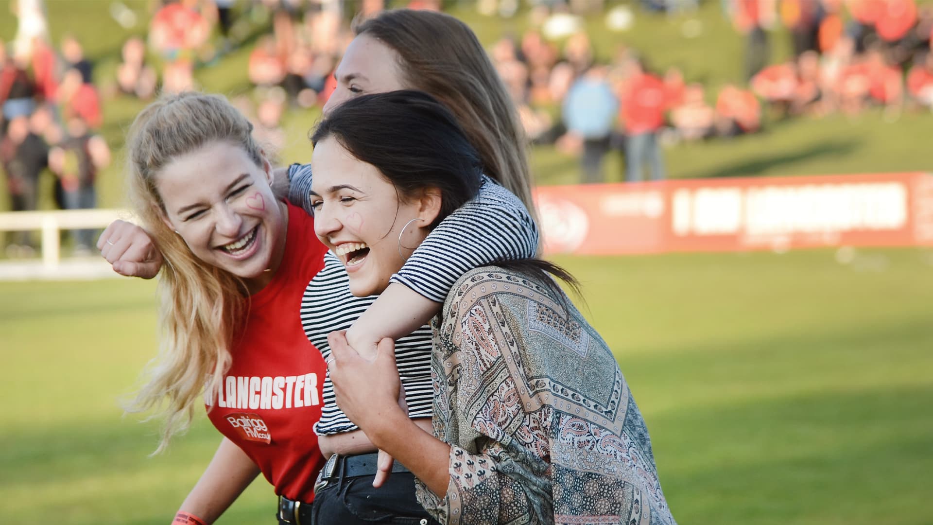 Three students celebrate victory in War of the Roses