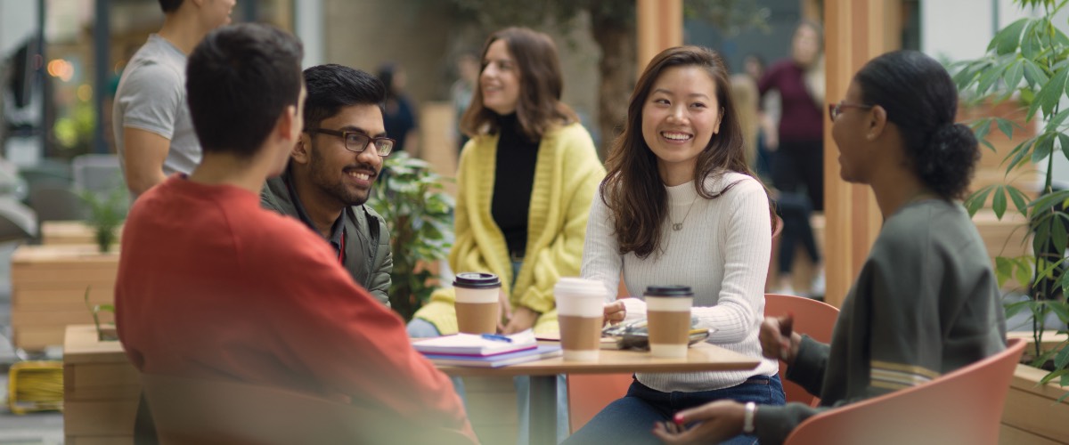 Students in the LEC Atrium sat around a table.