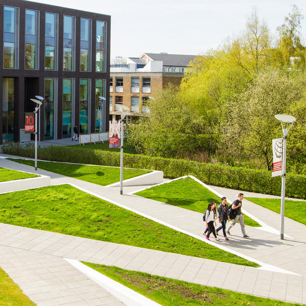 Students cross the open space by the George Fox building