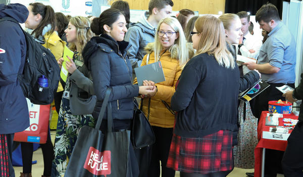 A group of femle students at a careers fair