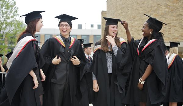 A group of graduates in robes and mortarboards