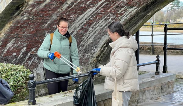 Two students picking up litter in Lancaster