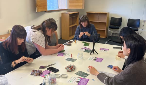 Students sat at a scrunchie making workshop