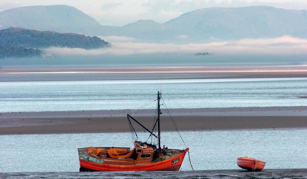 A red boat on Morecambe Bay
