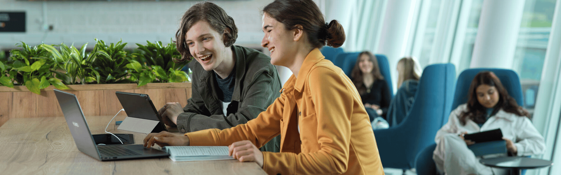 Students sat at a laptop