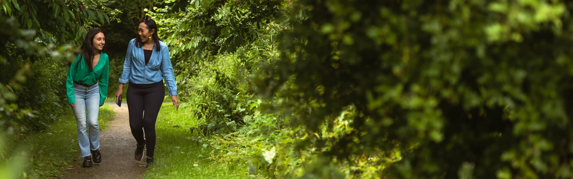 Students walking through the woods on campus