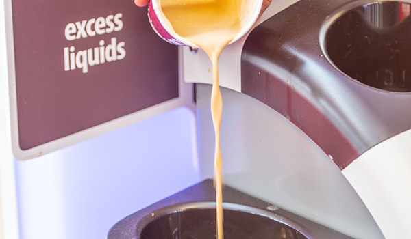 Excess coffee being poured into recycling.