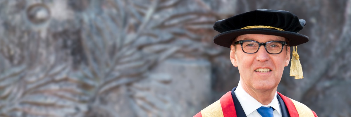 Chancellor Alan Milburn in a university cap and gown.