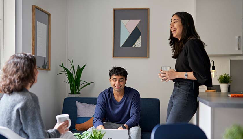 Students relaxing in social space in Lancaster University accommodation on campus.