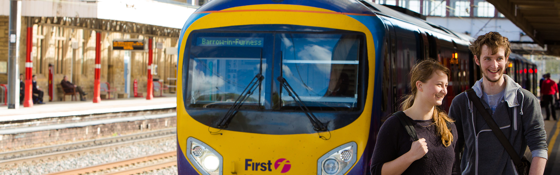 Two students on the platform at Lancaster train station