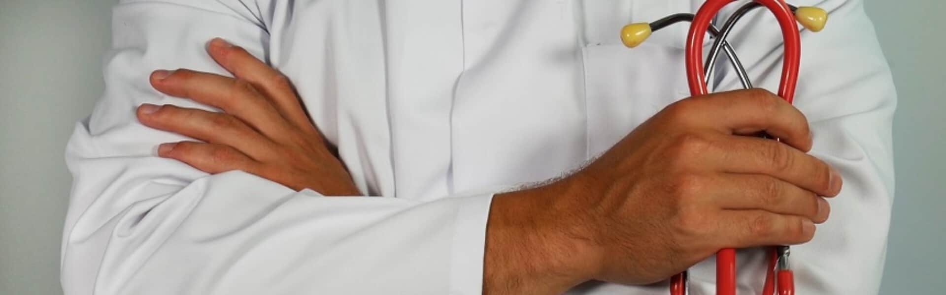 Doctor with crossed arms holding a stethoscope