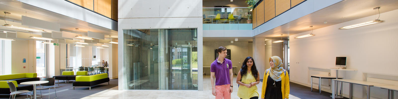 Students talking as they walk through the University campus.