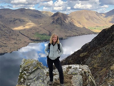 Kate stood on a mountain next to a lake